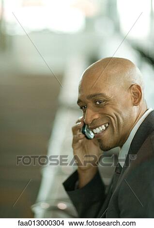 Businessman using cell phone, portrait View Large Photo Image Picture - Businessman using cell phone, portrait. Fotosearch