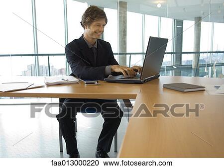 Businessman working with laptop View Large Photo Image Stock Image - Businessman working with laptop. Fotosearch