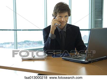 Businessman working with laptop View Large Photo Image Stock Photo - Businessman working with laptop. Fotosearch