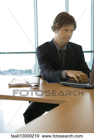 Stock Photo - Businessman working with laptop. Fotosearch