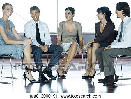 Businesspeople sitting in chairs having meeting, full length View Large Photo Image Stock Image - Businesspeople sitting in chairs having meeting, full length. Fotosearch