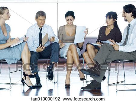 Businesspeople sitting in chairs having meeting, full length View Large Photo Image Stock Image - Businesspeople sitting in chairs having meeting, full length. Fotosearch
