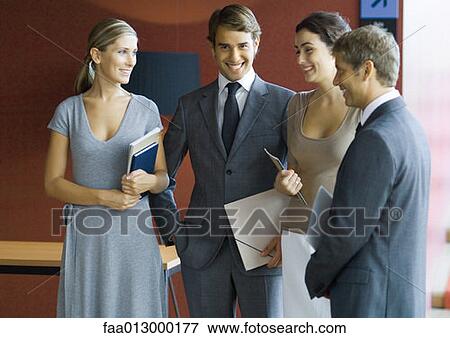 Businesspeople standing, talking View Large Photo Image Stock Photo - Businesspeople standing, talking . Fotosearch