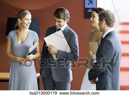 Businesspeople standing, talking View Large Photo Image Stock Photo - Businesspeople standing, talking . Fotosearch