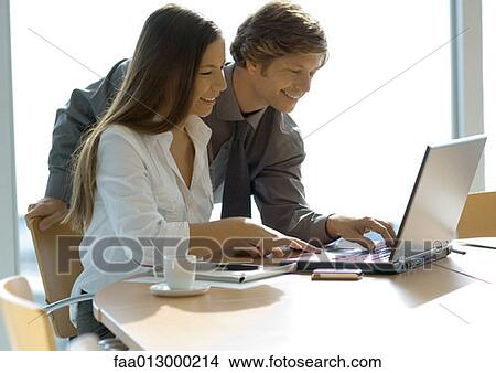 Businesswoman and man working with laptop View Large Photo Image Picture - Businesswoman and man working with laptop. Fotosearch