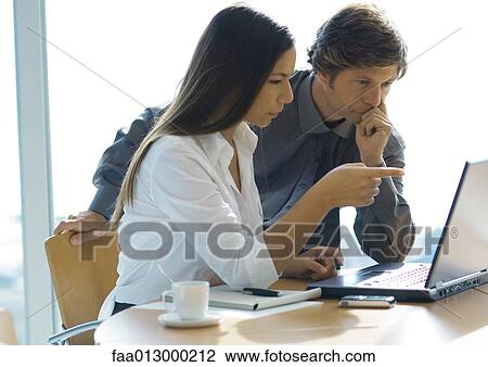 Businesswoman and man working with laptop View Large Photo Image Stock Image - Businesswoman and man working with laptop. Fotosearch