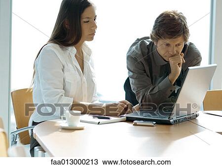 Businesswoman and man working with laptop View Large Photo Image Stock Image - Businesswoman and man working with laptop. Fotosearch