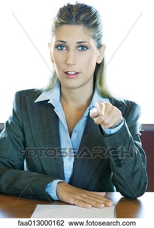 Businesswoman pointing at camera, portrait View Large Photo Image Stock Image - Businesswoman pointing at camera, portrait. Fotosearch