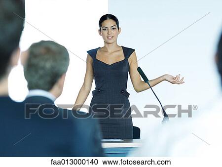 Businesswoman speaking with microphone during seminar View Large Photo Image Stock Image - Businesswoman speaking with microphone during seminar. Fotosearch