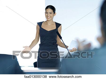 Businesswoman speaking with microphone during seminar View Large Photo Image Stock Photo - Businesswoman speaking with microphone during seminar. Fotosearch
