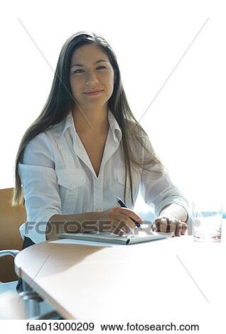 Businesswoman working at table View Large Photo Image Stock Photo - Businesswoman working at table. Fotosearch