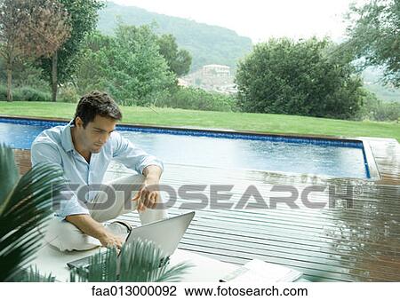 Casually dressed executive working by side of pool View Large Photo Image Stock Image - Casually dressed executive working by side of pool. Fotosearch