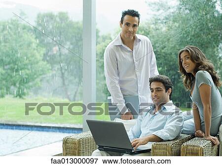 Casually dressed executives working by side of pool View Large Photo Image Stock Photo - Casually dressed executives working by side of pool. Fotosearch