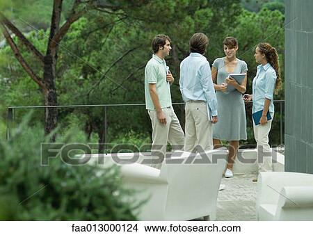 Casually dressed young executives working outdoors View Large Photo Image Picture - Casually dressed young executives working outdoors. Fotosearch
