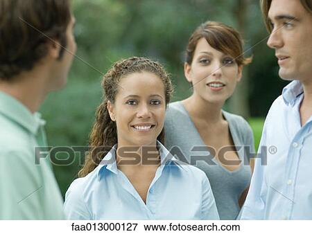 Casually dressed young executives outdoors, focus on woman View Large Photo Image Stock Photo - Casually dressed young executives outdoors, focus on woman. Fotosearch
