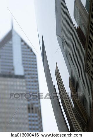 Distorted reflection of highrises, skyscraper in background View Large Photo Image Stock Photograph - Distorted reflection of highrises, skyscraper in background. Fotosearch