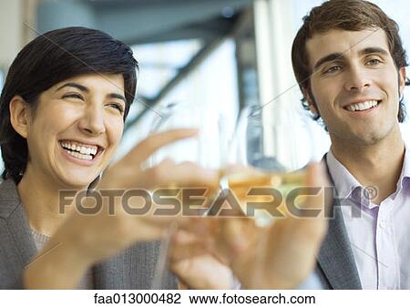 Executives clinking glasses of wine, close-up View Large Photo Image Stock Image - Executives clinking glasses of wine, close-up. Fotosearch