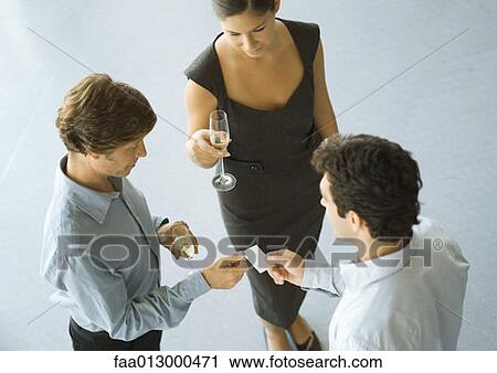 Executives exchanging business card during cocktail party View Large Photo Image Stock Image - Executives exchanging business card during cocktail party. Fotosearch