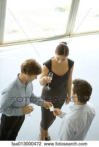 Executives exchanging business card during cocktail party View Large Photo Image Stock Image - Executives exchanging business card during cocktail party. Fotosearch