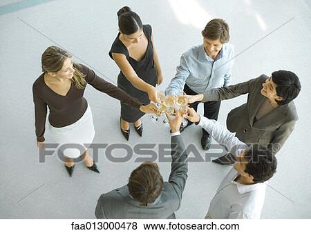 Executives making a toast during cocktail party, high angle view View Large Photo Image Stock Photo - Executives making a toast during cocktail party, high angle view. Fotosearch