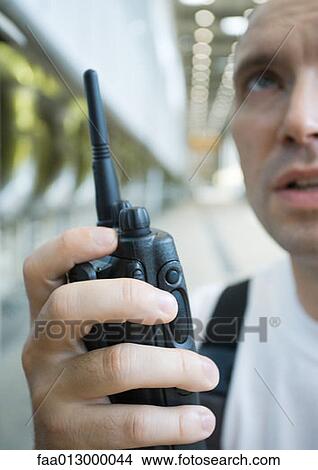 Factory worker using walkie talkie View Large Photo Image Picture - Factory worker using walkie talkie. Fotosearch