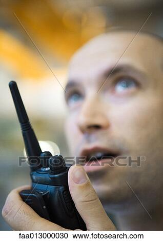 Factory worker using walkie talkie View Large Photo Image Stock Image - Factory worker using walkie talkie. Fotosearch
