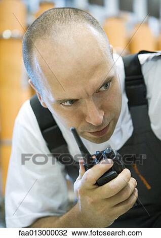 Factory worker using walkie talkie View Large Photo Image Stock Image - Factory worker using walkie talkie. Fotosearch