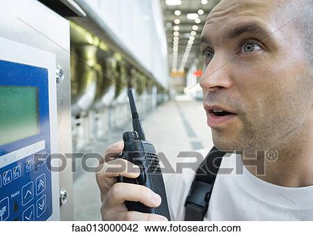 Factory worker using walkie talkie View Large Photo Image Stock Image - Factory worker using walkie talkie. Fotosearch