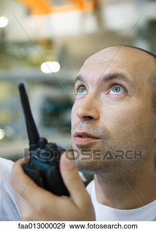Factory worker using walkie talkie View Large Photo Image Stock Photo - Factory worker using walkie talkie. Fotosearch