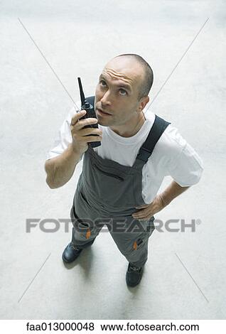 Factory worker using walkie talkie View Large Photo Image Stock Photo - Factory worker using walkie talkie. Fotosearch
