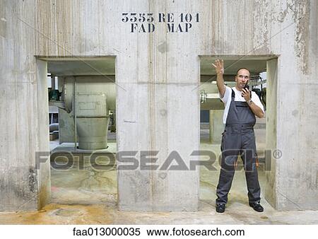 Factory worker using walkie talkie View Large Photo Image Stock Photography - Factory worker using walkie talkie. Fotosearch