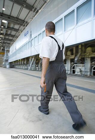 Factory worker walking View Large Photo Image Stock Image - Factory worker walking. Fotosearch