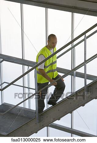 Factory worker walking up stairs View Large Photo Image Stock Photography - Factory worker walking up stairs. Fotosearch