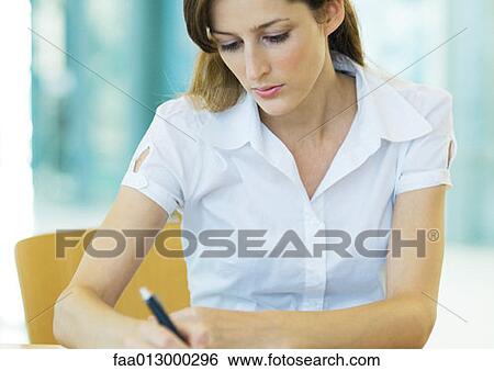 Female office worker writing View Large Photo Image Stock Photograph - Female office worker writing. Fotosearch