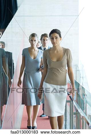 Group of businesspeople walking toward camera View Large Photo Image Stock Image - Group of businesspeople walking toward camera. Fotosearch