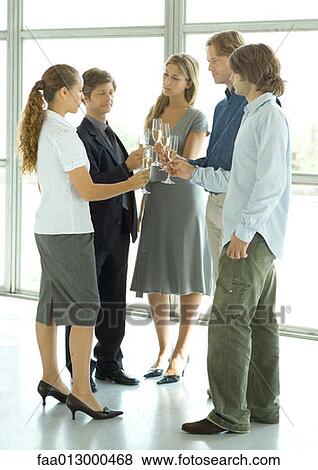 Stock Photo - Group of executives making a toast during cocktail party. Fotosearch