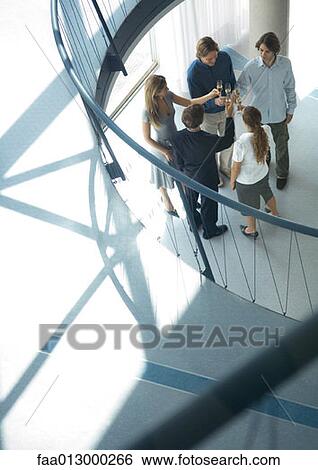 Group of young executives making toast, high angle view View Large Photo Image Stock Photograph - Group of young executives making toast, high angle view. Fotosearch