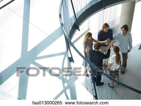 Group of young executives making toast, high angle view View Large Photo Image Stock Photography - Group of young executives making toast, high angle view. Fotosearch