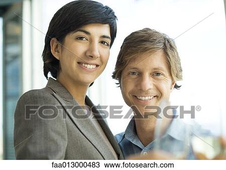 Male and female executive, smiling, clinking glasses View Large Photo Image Stock Image - Male and female executive, smiling, clinking glasses. Fotosearch
