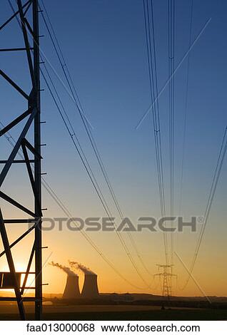 Nuclear cooling towers and electric wires and pylon at sunset View Large Photo Image Stock Photo - Nuclear cooling towers and electric wires and pylon at sunset . Fotosearch