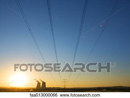 Nuclear cooling towers and electric wires and pylon at sunset View Large Photo Image Stock Photograph - Nuclear cooling towers and electric wires and pylon at sunset . Fotosearch