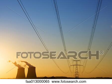 Nuclear cooling towers and electric wires and pylon at sunset View Large Photo Image Stock Photography - Nuclear cooling towers and electric wires and pylon at sunset . Fotosearch