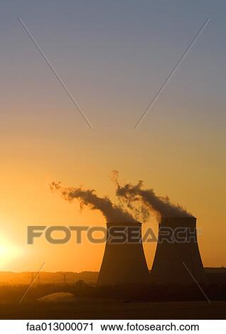 Stock Image - Nuclear cooling towers at sunset. Fotosearch