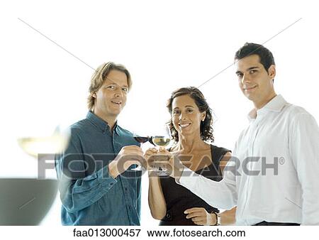 Stock Photo - People making a toast with glasses of wine. Fotosearch