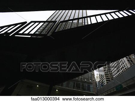 Picture - Silhouette of walkway and high rise building, low angle view. Fotosearch