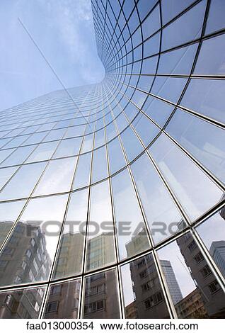 Skyscraper with reflection of buildings on facade, low angle, abstract view View Large Photo Image Picture - Skyscraper with reflection of buildings on facade, low angle, abstract view. Fotosearch