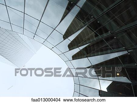 Picture - Skyscraper with reflection of buildings on facade, low angle, abstract view. Fotosearch