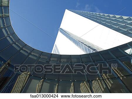 Skyscraper with reflection of buildings on facade, low angle, abstract view View Large Photo Image Picture - Skyscraper with reflection of buildings on facade, low angle, abstract view. Fotosearch