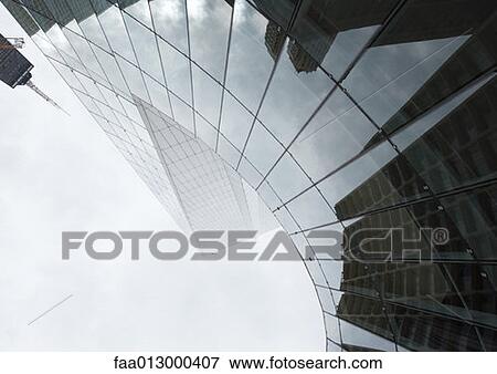 Skyscraper with reflection of buildings on facade, low angle, abstract view View Large Photo Image Stock Photo - Skyscraper with reflection of buildings on facade, low angle, abstract view. Fotosearch