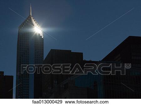 Skyscraper with sun glaring on corner View Large Photo Image Stock Photo - Skyscraper with sun glaring on corner. Fotosearch